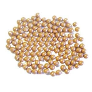 Loose pile of round tan Macrobrill polishing media beads for vibratory tumblers